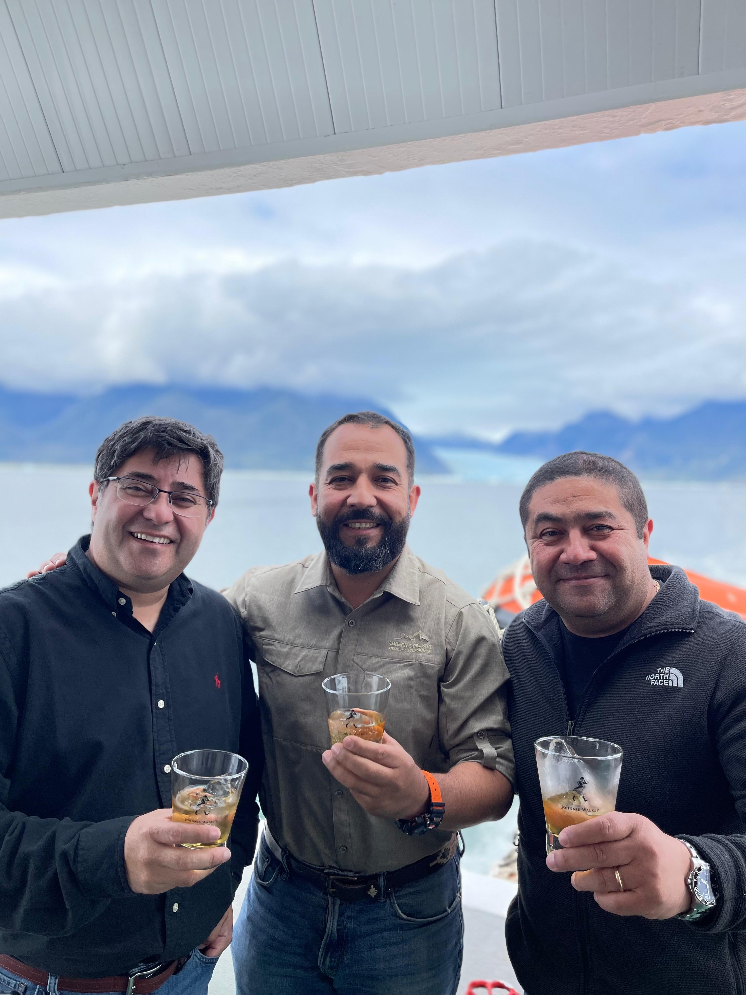 Hosts and guests enjoying glacier views with a toast